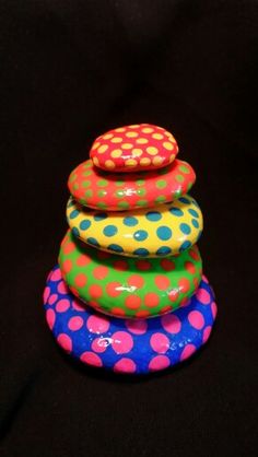 colorful rocks stacked on top of each other in the shape of a stack with polka dots