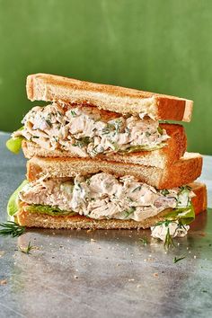 a chicken salad sandwich cut in half on a table