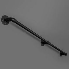 a black metal pole with two hooks on it's end and one hook attached to the wall