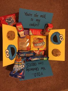 an assortment of cookies and candy in a box with a note to someone on the inside