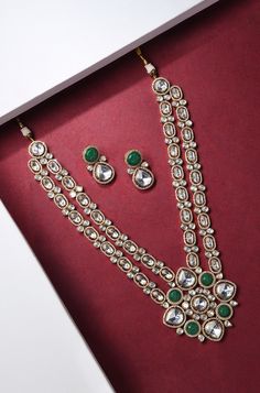 Introducing an exquisite double-layer Kundan necklace adorned with radiant Kundan stones, accompanied by matching earrings, all set in mixed metal with opulent 22kt gold plating, offering an enchanting blend of tradition and elegance. Finish: 22KT Gold Plating Material: Brass, Kundan Color: Gold, Green & White Size: Free Size, Adjustable Closure Type: Draw String Box Contains: 1 Necklace, 1 Pair of Earrings Festive Kundan Metal Necklace, Green Kundan Necklace With Gemstone, Gold Dual-tone Kundan Necklace Gift, Green Hand-set Kundan Necklace, Dual-tone Metal Kundan Necklace For Gift, Elegance Fashion, Chain Braid, Hand Jewelry Rings, Artificial Jewelry