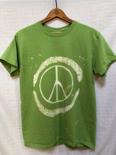 Unisex Medium Green 6 oz. 100% Cotton T-shirt  Peace sign with fern design painted by hand with bleach Shirt has been washed to ensure full bleach removal from fabric Painting Shirt Ideas, Green Peace Sign, Peace Sign Shirt, Painted T Shirt, Peace Sign Shirts, Fern Design, Bleach Shirt, Green Peace, Roblox Clothing