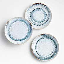 three blue and white plates sitting next to each other