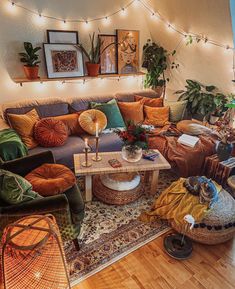 a living room filled with lots of furniture and plants on top of the couches