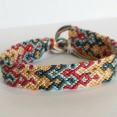 two braided bracelets sitting on top of a table