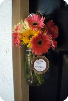 a vase filled with colorful flowers sitting on top of a door