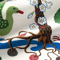 the fabric has an image of a giraffe and birds on it, with flowers