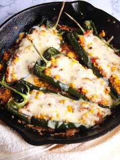 a skillet filled with green beans and cheese