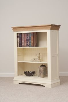 a white book shelf with books on it