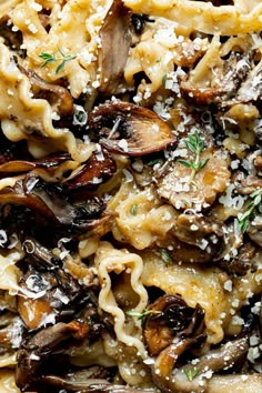 pasta with mushrooms and parmesan cheese on top