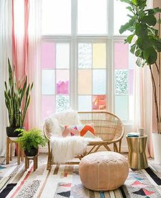 a living room filled with lots of plants and furniture