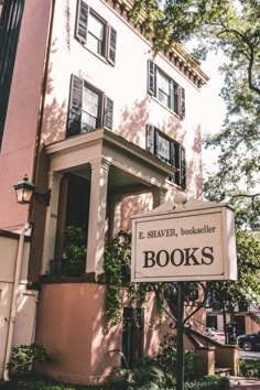 a sign that is in front of a building with books written on it and windows