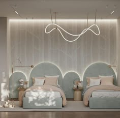 two beds in a room with lights above them