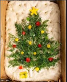 a christmas tree made out of dough with candies on the bottom and green branches