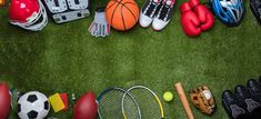 various sports equipment arranged in the shape of a circle on green grass with copy space