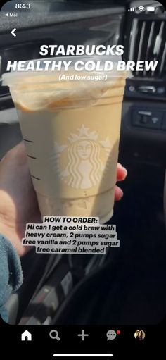 someone holding up a starbucks drink in their hand