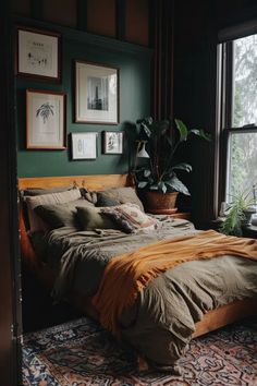 a bed sitting next to a window in a room with green walls and pictures on the wall