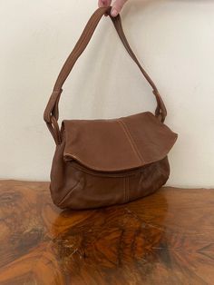 "Vintage Brown Leather purse, shoulder bag, 1970s, slightly distressed, Boho purse, Whiskey brown, Hippie purse Nice solid all leather 1970s brown leather purse Good condition, sound construction some light marks on the back. No damage Flap over closure 3 seperate sections. 1 zippered 1 center 1 large main section Measurements: 9\" x 13\" x 3\" Strap drop: 15\" NK528DR Vintage Brown Leather purse, shoulder bag, 1970s, slightly distressed, Boho purse, Whiskey brown, Hippie purse" Retro Vintage Brown Soft Leather Bag, Retro Vintage Brown Shoulder Bag For Everyday, Retro Brown Leather Shoulder Bag, Retro Brown Soft Leather Shoulder Bag, Retro Brown Satchel With Removable Pouch, Vintage Brown Soft Leather Bag, Vintage Distressed Brown Leather Shoulder Bag, Vintage Brown Shoulder Bag For Everyday, Vintage Brown Shoulder Bag Satchel