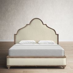 a white bed sitting on top of a wooden floor