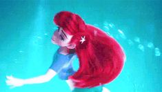 the little mermaid is swimming under water