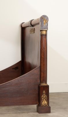 an antique wooden bed frame with brass accents