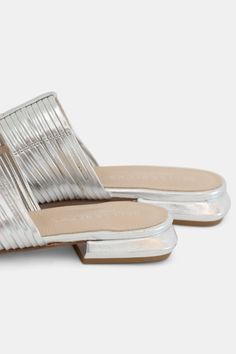 Strippy leather pointy toe mule in silver Silver Slip-on Mules For Party, Silver Slip-on Party Mules, Modern Silver Open Toe Mules, Pointed Toe Party Mules With Leather Sole, Party Pointed Toe Mules With Leather Sole, Silver Pointed Toe Mules For Summer, Summer Silver Pointed Toe Mules, Party Mules With Pointed Toe And Leather Sole, Metallic Mules For Spring Evening Occasions