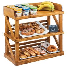 an assortment of donuts and other pastries on a wooden shelf