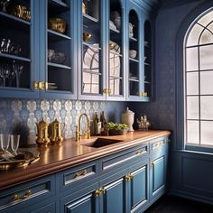 a kitchen with blue cabinets and gold trim on the counter tops is pictured in this image