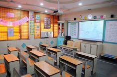 an empty classroom with wooden desks and chairs