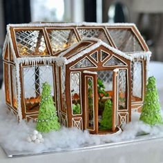 a ginger house with trees and snow around it