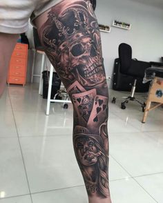 a man's leg with tattoos on it and skulls in the middle of his legs