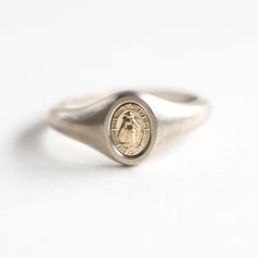 Virgin Mary signet ring
 Gorgeous minimalist Mary signet ring. DETAILS Band   Style: Minimalist Material:   14k Gold: yellow, white, rose  18k Gold: yellow, white, rose  Other Metal: platinum  Measurements: Mary measures 7x5mm approx
   Sizing: We are using US metric system  Customization Options This design can be made with gemstones of your choosing. If you would prefer a custom ring, please contact us before purchase. Procedure Information  Please select the material and ring size from the dr Rose Gold Open Signet Ring In Sterling Silver, Rose Gold Sterling Silver Open Signet Ring, White Gold Open Signet Ring With Engraving Option, Rose Gold Sterling Silver Signet Ring, Formal Rose Gold Sterling Silver Signet Ring, Minimalist White Gold Signet Ring For Promise, Minimalist Open Signet Ring With Engraving Option, Minimalist White Gold Dome Ring, Tarnish Resistant, Minimalist White Gold Dome Ring Tarnish Resistant