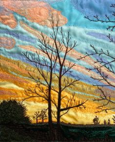 a painting of trees in the distance with colorful clouds behind them and an orange sky