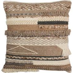 a brown and white pillow with fringes on it