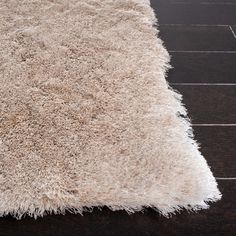 a white rug on a wooden floor