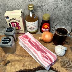 ingredients to make an entree laid out on a cutting board next to onion, garlic, and other condiments