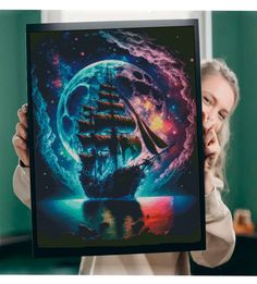 a woman holding up a poster with an image of a ship in the ocean on it