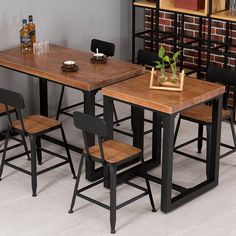 a dining table with four chairs and a potted plant on the counter top next to it