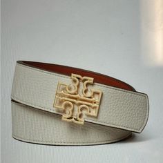 Brand New Tan/Orange Color All Sizes New Arrival Designer Belts With Gold-tone Hardware For Work, Designer White Leather Belts, Classic Leather Belt With Gold-tone Logo Plaque, Luxury Belts With Gold-tone Hardware, Luxury Leather Belts With Gold-tone Hardware, Luxury Brown Belts With Gold-tone Hardware, Reversible Belt, Orange Color, Tory Burch