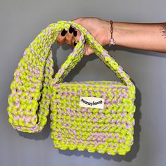 Make a bold fashion statement with this handmade knit bag in vibrant neon green and soft lilac! Designed with a long handle for easy crossbody wear, this bag is perfect for adding a pop of color to any outfit. Ideal for everyday use, festivals, or as a standout piece for special occasions. Details: Size: 7 inches in length and 22 inches in height (including handle) Design: Striking combination of neon green and lilac yarn for a fresh, modern look. Handmade with Care: Crafted by me in Los Angeles, each bag is unique and made with love. Custom Orders Available: Prefer a different color or size? Contact me for a custom order tailored to your style! Perfect Gift Idea: Great for birthdays, holidays, or just because. Care Instructions: Spot clean with a damp cloth to maintain the bag's bright co Neon Green Crochet, Trendy Green Knitted Shoulder Bag, Purple Crochet Bag For Everyday Spring Use, Trendy Green Knitted Bag, Purple Crochet Bag For Spring, Trendy Purple Crochet Bag For Daily Use, Trendy Hand Knitted Shoulder Bag, Trendy Yellow Crochet Bag, Trendy Handmade Yellow Crochet Bag