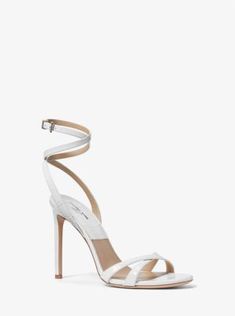 Designed to be worn with the season’s sarong skirts and trousers alike, the Chrissy sandal is crafted in Italy from crocodile-embossed leather. It features slim crossover straps at the toe and ankle, and rests on a leg-lengthening stiletto heel. With a simple yet sophisticated silhouette, it’ll fast become your go-to evening shoe. Elegant Ankle Wrap Fitted Sandals, Elegant Fitted Ankle Wrap Sandals, Luxury Ankle Wrap Sandals For Formal Occasions, Luxury Ankle Wrap Sandals For Formal Events, Luxury Formal Ankle Wrap Sandals, Luxury Ankle Wrap Sandals For Spring, Luxury Single Strap Sandals For Formal Events, Luxury Single Strap Formal Sandals, Elegant White Double Strap Sandals