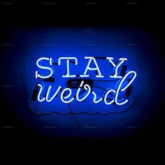 a neon sign that says stay weird