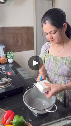 a woman standing in front of a stove preparing food on top of a frying pan