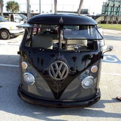 an old vw bus parked in a parking lot