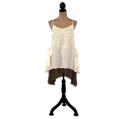 This layered dress features spaghetti straps crossed at the back and a romantic boho, mori vibe. The lace applique on the bodice and side ties also add a 20's style flapper feel to this unique loose fitting chemise. I love the creamy beige and brown combo and the high low hemline. Also available in Blue/Gray here: https://www.etsy.com/listing/656680524/romantic-clothes-layered-dress-boho-mini?ref=shop_home_active_7 Each piece in our HEART ALTERED collection has been embellished with our signatur Bohemian Dresses With Straps, Bohemian Dress With Lace Patchwork And Spaghetti Straps, Bohemian Spaghetti-strap Dress With Lace Patchwork, Bohemian Dress With Spaghetti Straps And Ruffles, Bohemian Spaghetti Strap Dress With Ruffles, Bohemian Sleeveless Dress For Layering, Bohemian Lace Camisole For Spring, Bohemian Brunch Dresses With Straps, Spring Bohemian Lace Camisole