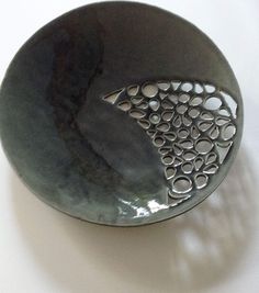 a black bowl sitting on top of a white table