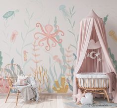 a child's room with pink and green wallpaper, an octopus tent, two chairs, and a crib