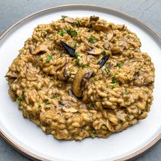 a white plate topped with rice and mushrooms