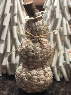 a snowman made out of seashells on a table