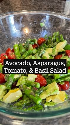 a salad in a glass bowl with the words avocado, asparagus, tomato and basil salad